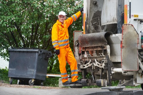 Workers handling potentially hazardous waste with PPE